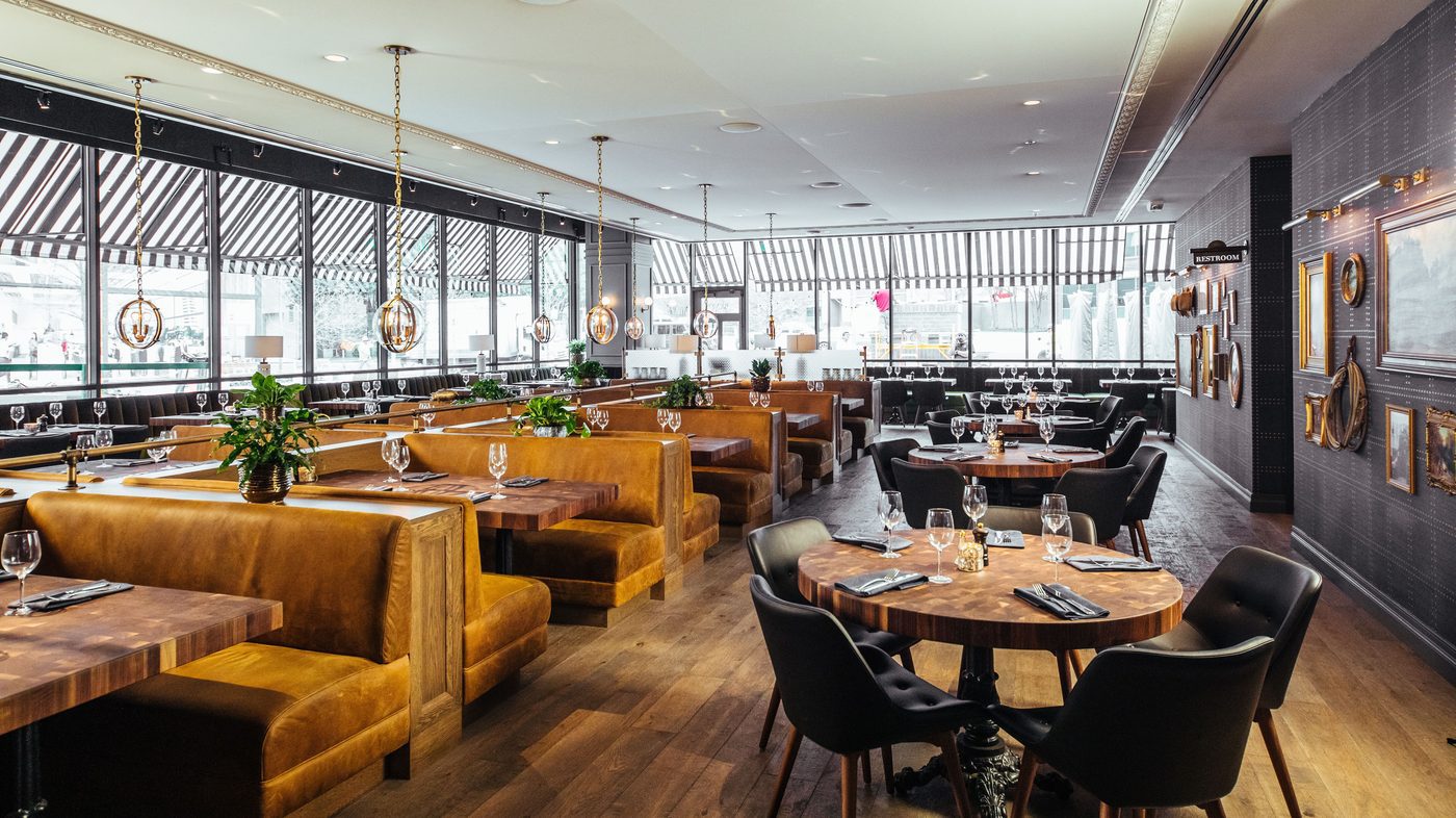Designform Niro chairs beside mustard leather booths at The Henry, Dallas.