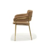 Luna Chair - Side view, gold steel frame with upholstered seat and back