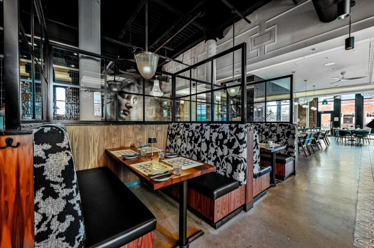 Booths with Designform American black walnut table tops at Nero, Edmonton, AB