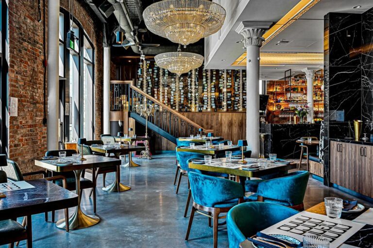 Nero dining room in Edmonton, AB with Designform Gabrielle chairs and brass table bases